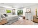 Bright bedroom with slider to patio, white walls, ceiling fan, and neutral decor at 106 Midway Is, Clearwater Beach, FL 33767