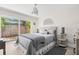 Comfortable bedroom with natural light, stylish bedding, and a ceiling fan at 106 Midway Is, Clearwater Beach, FL 33767