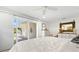 Bright primary bedroom with ceiling fan, natural light, and slider door to patio at 106 Midway Is, Clearwater Beach, FL 33767
