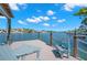 Waterfront home featuring a private dock with seating and scenic water views at 106 Midway Is, Clearwater Beach, FL 33767