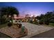 Well-maintained house with neat landscaping, a brick driveway, and exterior lighting enhancing its charm at 106 Midway Is, Clearwater Beach, FL 33767