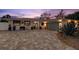 Charming home exterior with well-maintained landscaping and a brick driveway at dusk at 106 Midway Is, Clearwater Beach, FL 33767