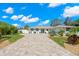 Charming home showcases a beautifully landscaped front yard and an inviting entrance with decorative touches at 106 Midway Is, Clearwater Beach, FL 33767