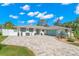 Attractive exterior features well-maintained landscaping and a spacious driveway, blending comfort and style at 106 Midway Is, Clearwater Beach, FL 33767