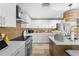 Open concept kitchen with quartz countertops, stainless steel appliances and designer lighting at 106 Midway Is, Clearwater Beach, FL 33767