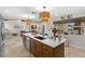 Open concept kitchen features large island with storage, stainless appliances, and view to the living area at 106 Midway Is, Clearwater Beach, FL 33767