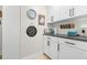 Bright laundry room with ample storage, modern cabinets, and stylish decorative touches at 106 Midway Is, Clearwater Beach, FL 33767