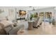 Comfortable living room has a fireplace, TV, and glass doors opening to a pool view at 106 Midway Is, Clearwater Beach, FL 33767