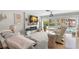 Cozy living room with a fireplace and views of a boat dock, ideal for relaxing and entertaining at 106 Midway Is, Clearwater Beach, FL 33767