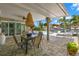Inviting outdoor patio with a covered seating area, fan, and views of the pool and canal at 106 Midway Is, Clearwater Beach, FL 33767