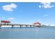 Scenic view of a pier extending into calm, clear blue water under a bright sky at 106 Midway Is, Clearwater Beach, FL 33767