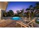 Relaxing pool area with lounge chairs and tropical landscaping, near a private dock at 106 Midway Is, Clearwater Beach, FL 33767