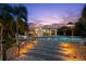 The backyard boasts a beautiful pool and a home with an outdoor seating area, ideal for relaxation and entertainment at 106 Midway Is, Clearwater Beach, FL 33767