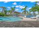 Inviting pool area with patio, lounge chair, and dock with a boat lift on the canal at 106 Midway Is, Clearwater Beach, FL 33767