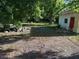 Spacious backyard needing yardwork and cleanup, with a shed on the side at 1118 E Linebaugh Ave, Tampa, FL 33612