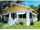 Quaint single-story home with awnings and a covered porch, needs yardwork and minor repairs at 1118 E Linebaugh Ave, Tampa, FL 33612