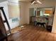 Bright living room featuring laminate floors, a ceiling fan and a view into the next room at 1118 E Linebaugh Ave, Tampa, FL 33612