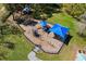 Aerial view of the community playground showcasing slides and climbing equipment in a grassy area at 1126 Tarridon Ct, Dunedin, FL 34698
