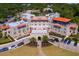 Aerial view of the Fenway Hotel showcasing its elegant architecture and lush landscaping at 1126 Tarridon Ct, Dunedin, FL 34698