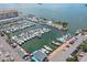 Aerial view of a large marina filled with many boats and a waterfront building along the harbor at 1126 Tarridon Ct, Dunedin, FL 34698
