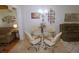 Cozy dining area featuring a glass table and comfortable seating, adjacent to the living room at 1126 Tarridon Ct, Dunedin, FL 34698