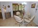 Bright dining area featuring a glass table and seating for four, with views of the exterior at 1126 Tarridon Ct, Dunedin, FL 34698