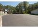 Wide angle view of community entrance showcasing a gated entrance and lush greenery at 1126 Tarridon Ct, Dunedin, FL 34698