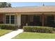 Charming exterior view of the home showcasing the front entrance and landscaping at 1126 Tarridon Ct, Dunedin, FL 34698