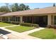 Exterior of building showing well-maintained landscaping and assigned parking at 1126 Tarridon Ct, Dunedin, FL 34698