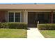 Close up of a home's front porch with a well-kept lawn and charming facade at 1126 Tarridon Ct, Dunedin, FL 34698