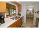 Bright kitchen featuring stainless steel appliances and a window to the sunroom at 1126 Tarridon Ct, Dunedin, FL 34698