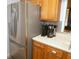 Kitchen showcasing stainless steel appliances, wooden cabinets, and a practical countertop layout at 1126 Tarridon Ct, Dunedin, FL 34698