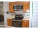 Efficient kitchen setup with modern stainless steel oven and a sleek, tiled backsplash at 1126 Tarridon Ct, Dunedin, FL 34698