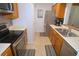 Functional kitchen layout with stainless steel appliances, ample cabinet space, and tile flooring at 1126 Tarridon Ct, Dunedin, FL 34698