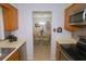 Efficient kitchen layout with stainless steel appliances and a view into the dining area at 1126 Tarridon Ct, Dunedin, FL 34698