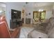 Well-lit living room with tile floors, a ceiling fan, and views into dining area and kitchen at 1126 Tarridon Ct, Dunedin, FL 34698