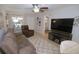 Bright living room showcasing tile floors, a modern ceiling fan and access to the screened in lanai at 1126 Tarridon Ct, Dunedin, FL 34698