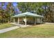 Enjoy outdoor dining at the covered picnic area, complete with tables and lush green surroundings at 1126 Tarridon Ct, Dunedin, FL 34698