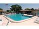 Community pool featuring lounge chairs, shade, and ample space for swimming and recreation at 1126 Tarridon Ct, Dunedin, FL 34698