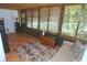 Bright sun room featuring terra cotta tile flooring, neutral colored sofa, and natural light with window treatments at 1126 Tarridon Ct, Dunedin, FL 34698