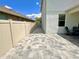 Pavered backyard showcasing a spacious area for outdoor activities and easy access to the covered patio at 1147 Halapa Way, Trinity, FL 34655