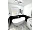 Modern bathroom with a soaking tub, contemporary fixtures, and stylish design at 1147 Halapa Way, Trinity, FL 34655