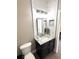 Updated bathroom features a stylish vanity, modern lighting, and decorative accent tile at 1147 Halapa Way, Trinity, FL 34655