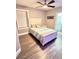 Comfortable bedroom featuring a ceiling fan and ensuite bathroom at 1147 Halapa Way, Trinity, FL 34655