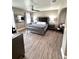 Elegant bedroom with a tufted headboard bed, ceiling fan, and stylish decor at 1147 Halapa Way, Trinity, FL 34655