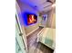 Cozy bedroom with decorative fireplace and ensuite bathroom at 1147 Halapa Way, Trinity, FL 34655