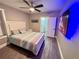 Comfortable bedroom featuring a ceiling fan and ensuite bathroom at 1147 Halapa Way, Trinity, FL 34655