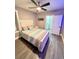 Comfortable bedroom featuring a ceiling fan and ensuite bathroom at 1147 Halapa Way, Trinity, FL 34655