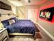 Bedroom with hardwood floors, a ceiling fan, a bed, a tv, and a feather on the wall at 1147 Halapa Way, Trinity, FL 34655