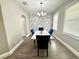 Contemporary dining room showcasing a marble table, stylish chairs, and a modern light fixture at 1147 Halapa Way, Trinity, FL 34655